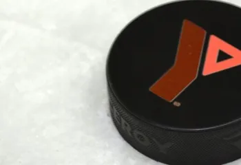 A hockey puck with the Y logo