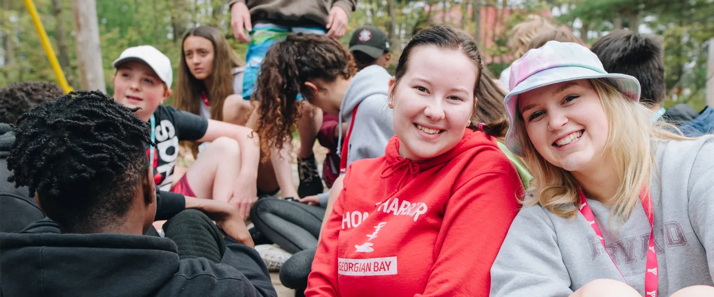 Two smiling camp councilors having fun.