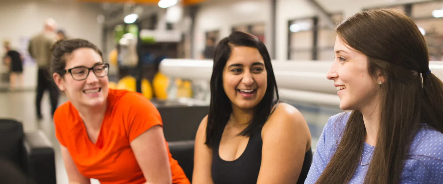 Three woman sitting together having a conversation.