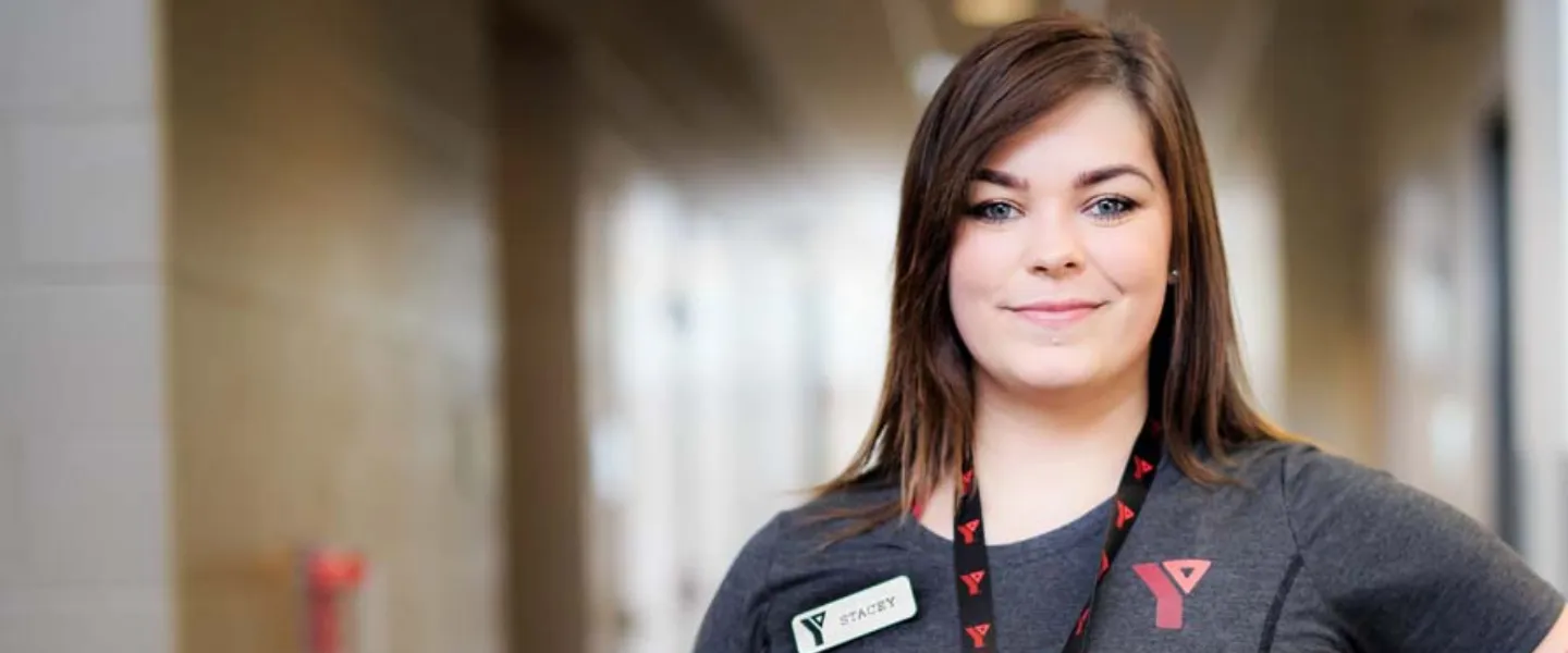 Female Y staff person smiles at camera.