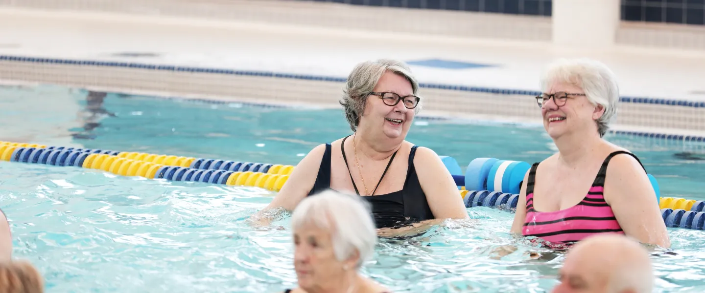 A group of seniors enjoy the pool.