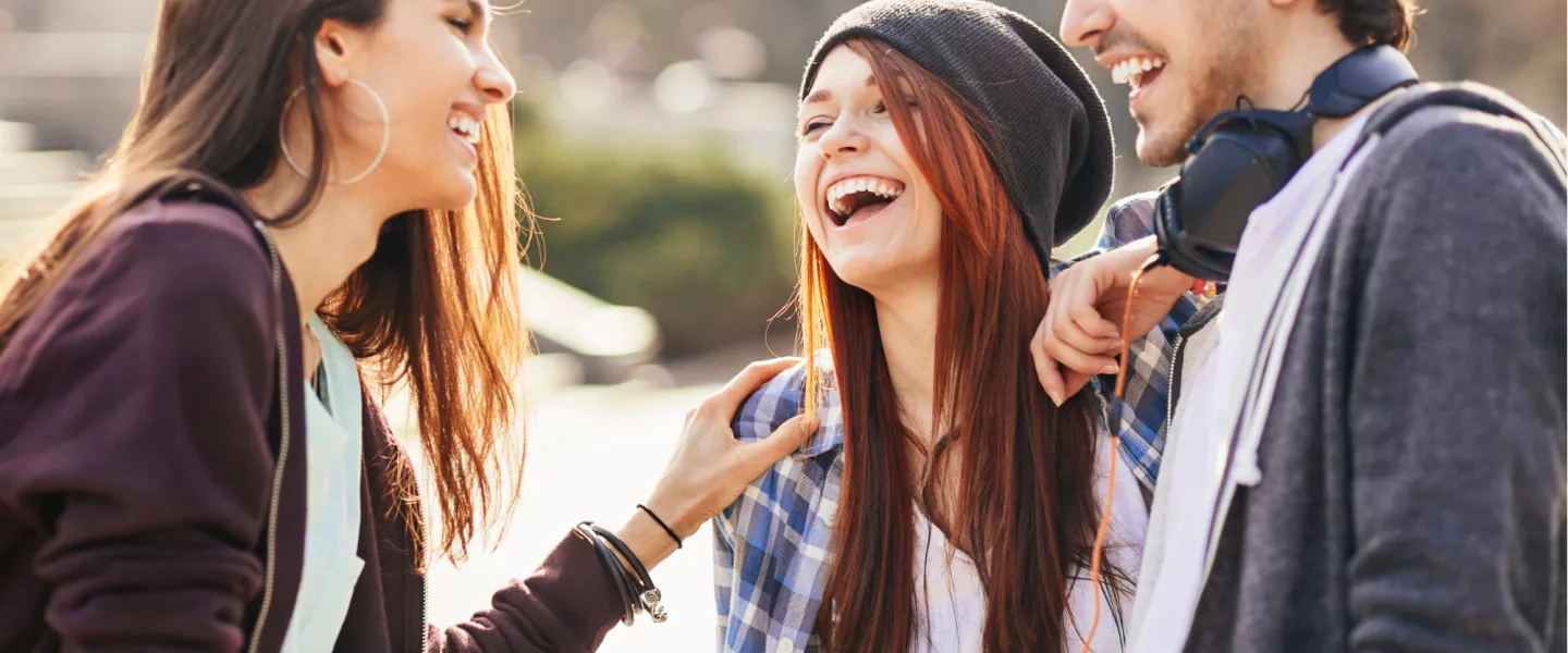 A group of youths talking and laughing.