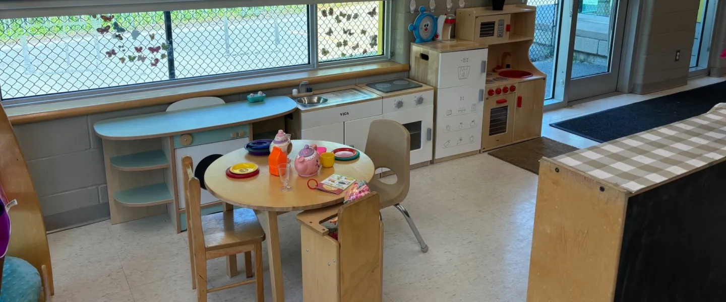 Avalon child care area with play kitchen and dining room set