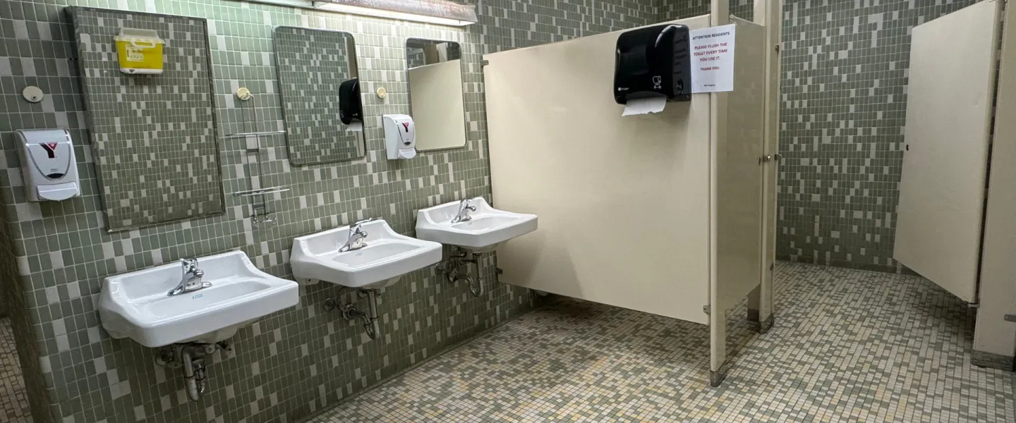 Shared bathroom with sinks and stalls