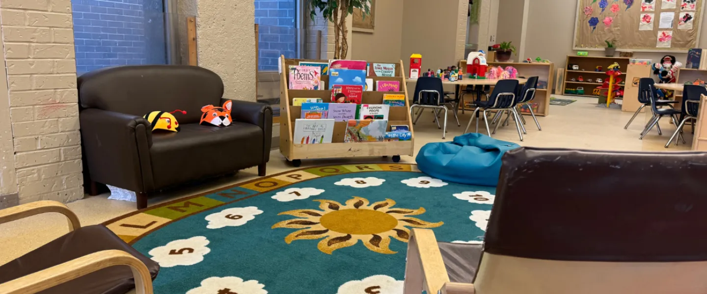 A rug and seating area with books at the Taggart Child Care Centre