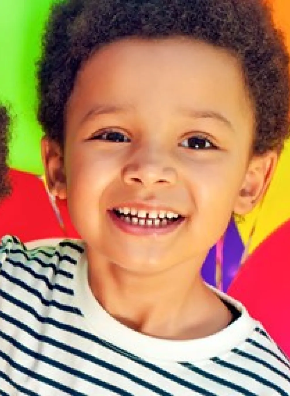 Two boys surrounded by brightly coloured balloons