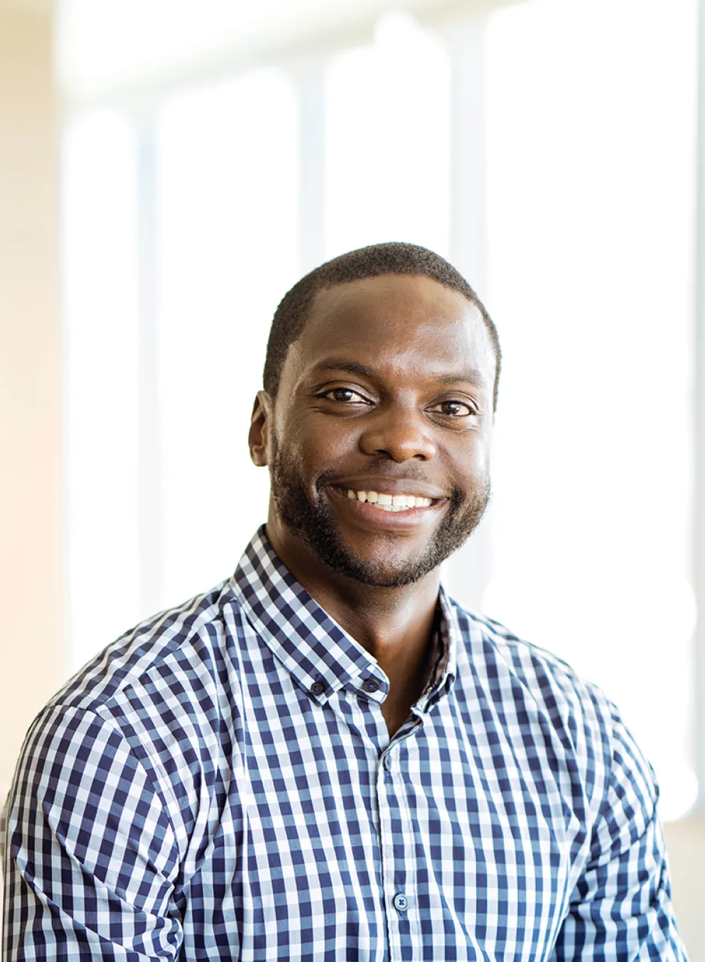 A smiling man in a classroom setting.