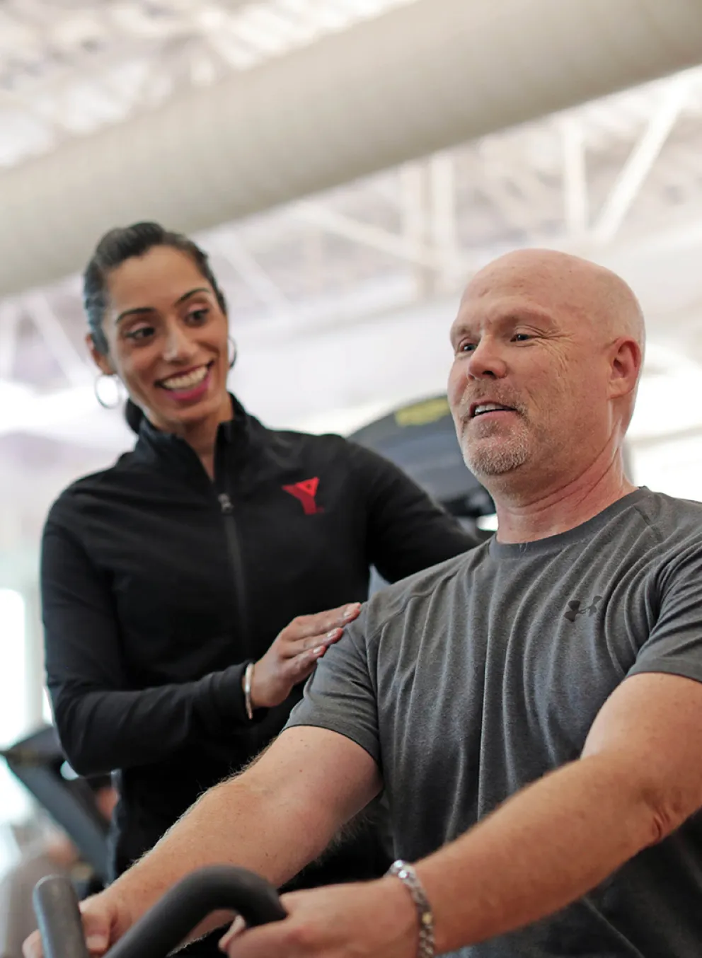 A YMCA personal trainer working with their client.