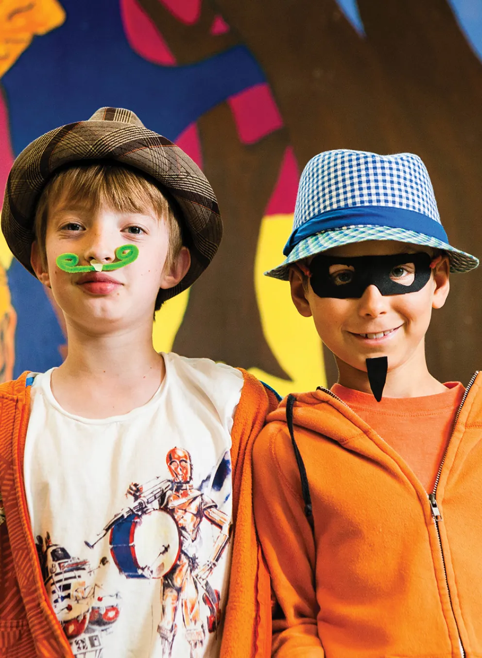 Two boys wearing costumes they made at camp.