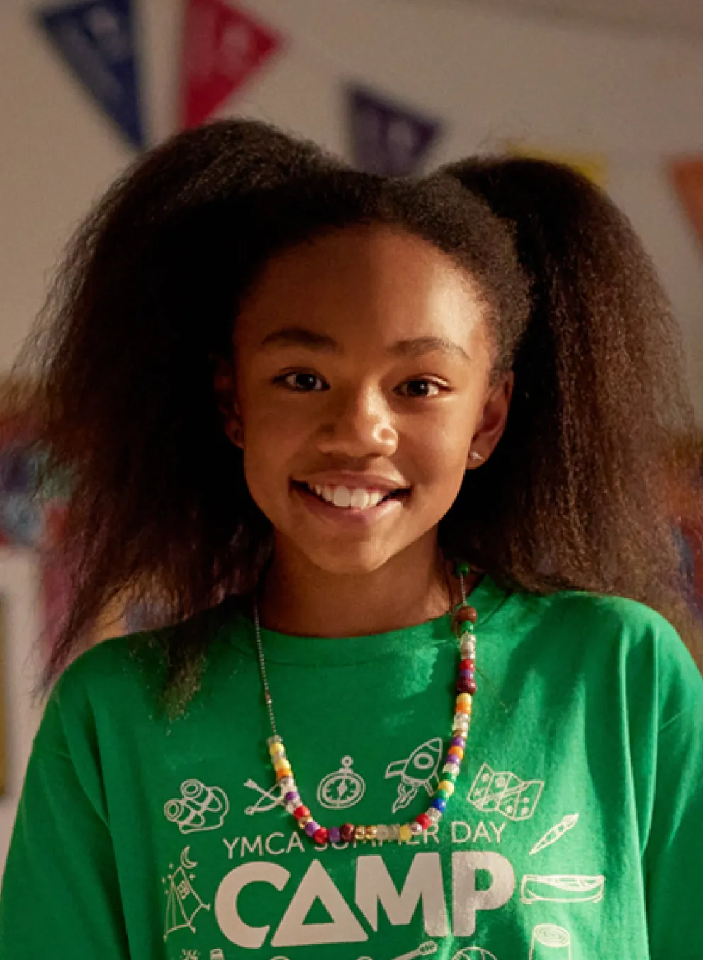 Young girl at camp smiling.