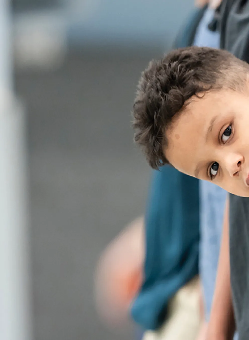 A diverse group of children lined up, all looking forward with cheerful expressions