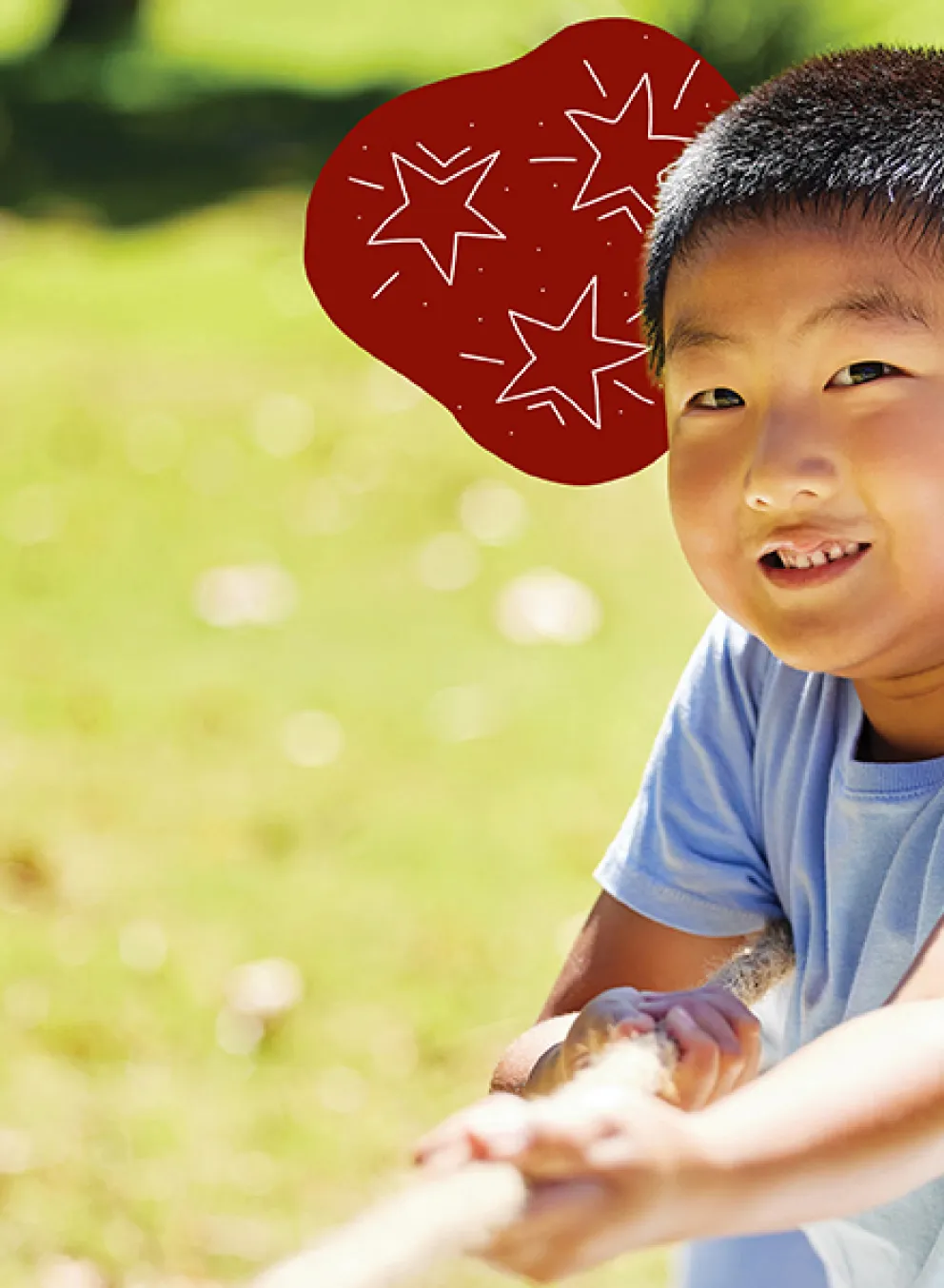 A cheerful boy stands in a vibrant field, smiling brightly as he enjoys the sunny day.