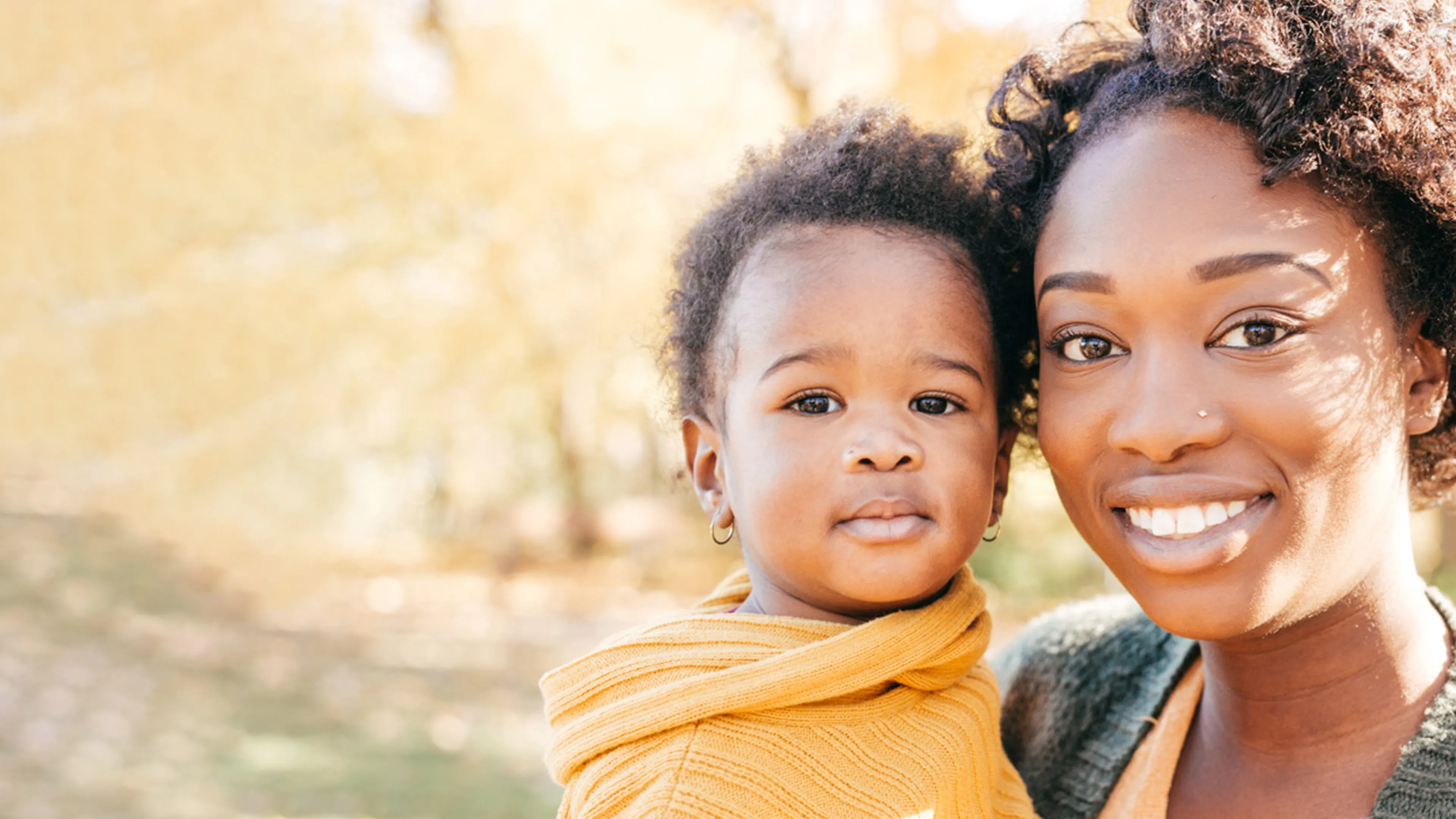 A woman poses with her child.