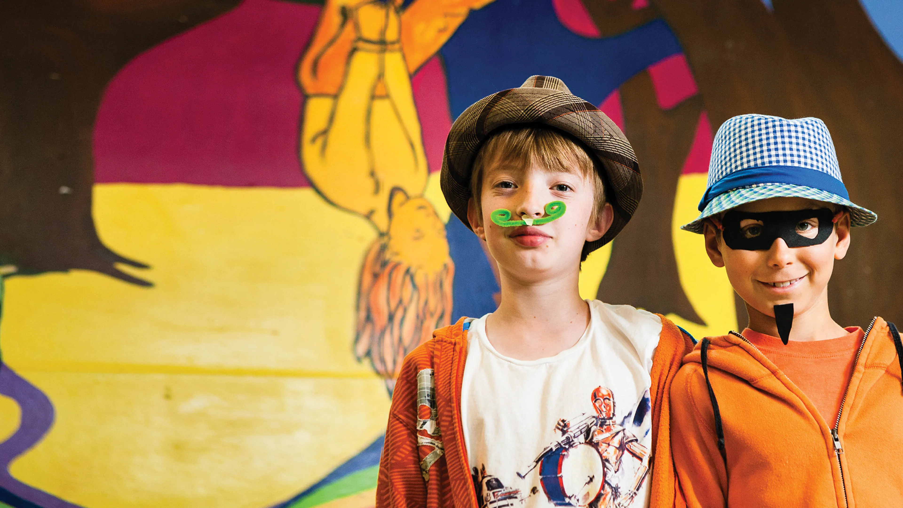 Two boys wearing costumes they made at camp.