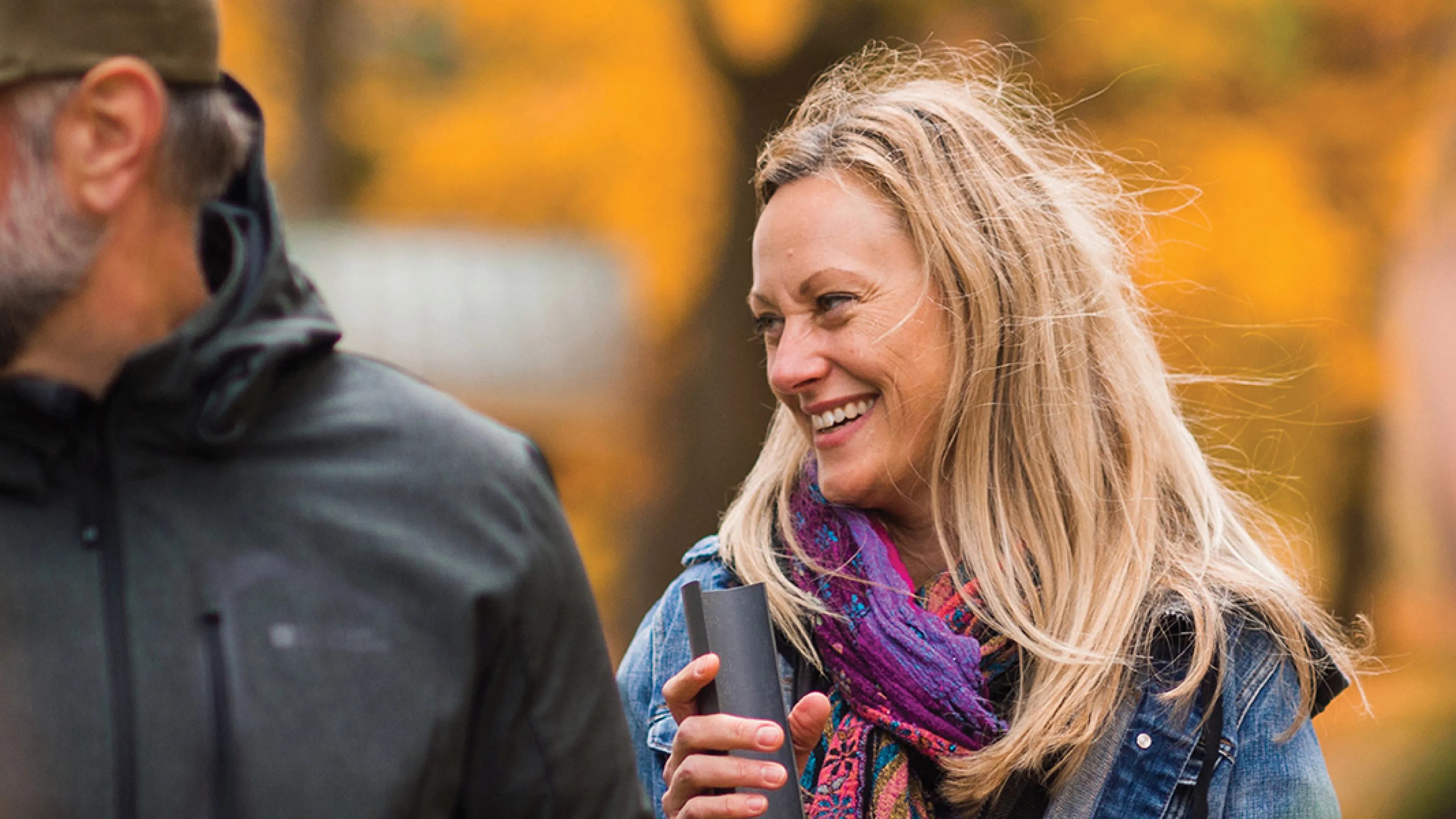 A group of adults participate in a team building exercise in an outdoor setting.