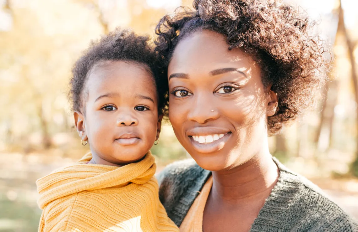 A woman poses with her child.