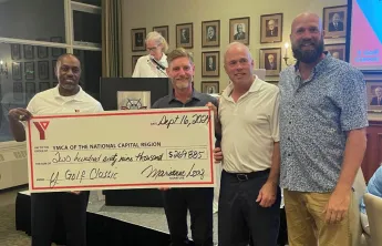 A group of people holding a large cheque for $270,000