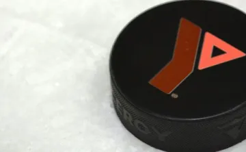 A hockey puck with the Y logo