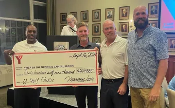 A group of people holding a large cheque for $270,000